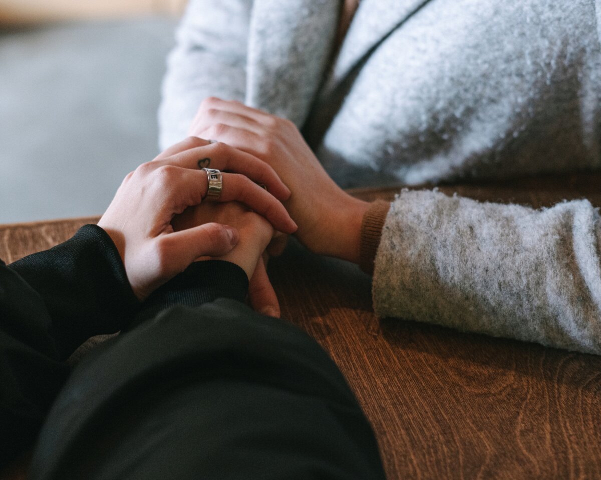 Hands reaching toward each other representing grief support and community in northern New Jersey